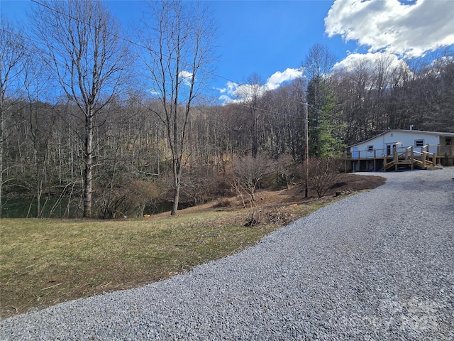 view of road featuring a forest view