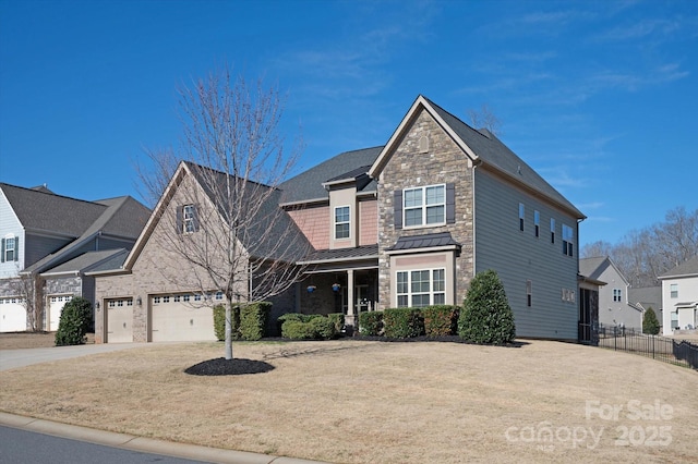 view of front of home featuring driveway, metal roof, an attached garage, a standing seam roof, and fence