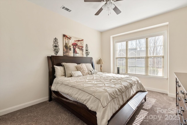 carpeted bedroom with visible vents, ceiling fan, and baseboards