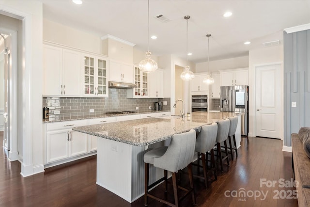 kitchen featuring stainless steel appliances, dark wood finished floors, and white cabinetry