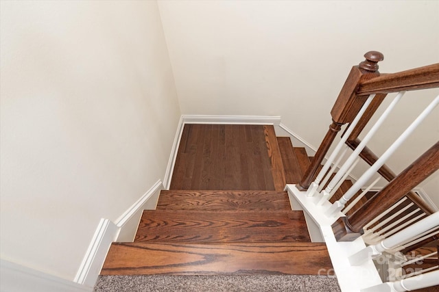 stairs with baseboards and wood finished floors