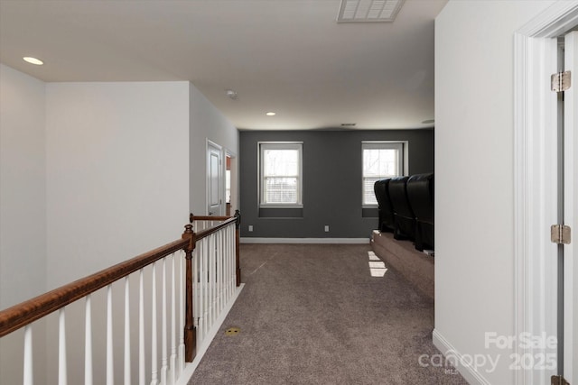 hallway with recessed lighting, carpet flooring, an upstairs landing, visible vents, and baseboards