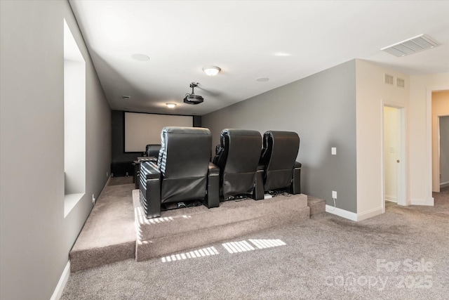 cinema room with carpet flooring, visible vents, and baseboards