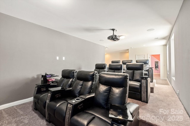 cinema room featuring light carpet and baseboards