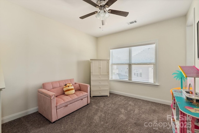 sitting room with ceiling fan, carpet floors, visible vents, and baseboards