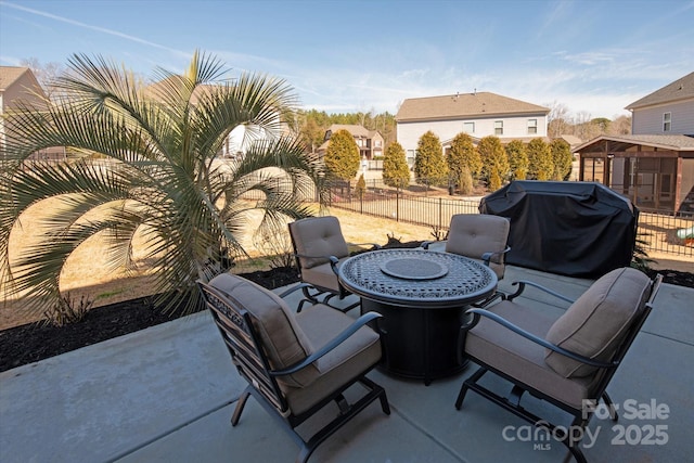 view of patio featuring a grill and fence