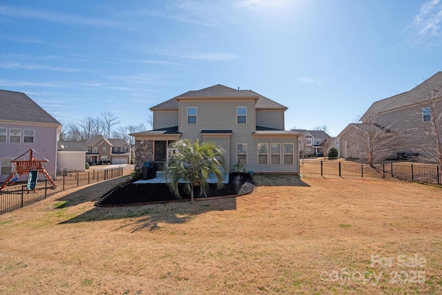 back of house featuring a yard, a patio area, and a fenced backyard