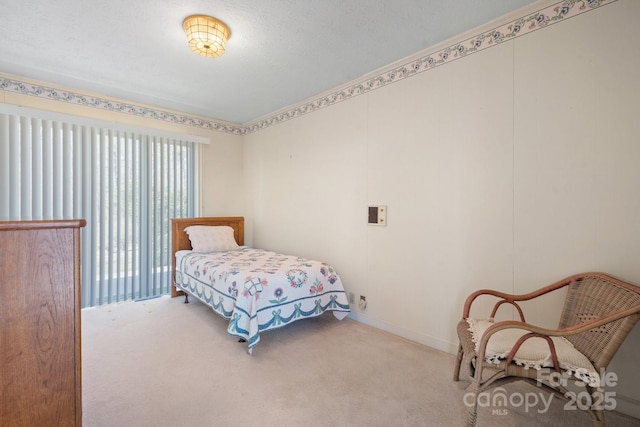 bedroom with baseboards and light colored carpet