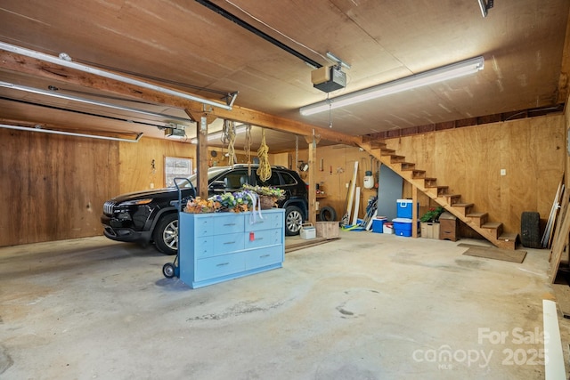 parking deck featuring wooden walls and a garage door opener