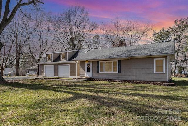 view of front of property featuring driveway, a shingled roof, a chimney, and a front yard