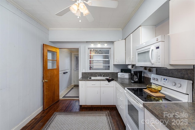 kitchen featuring white appliances, a sink, white cabinetry, dark wood-style floors, and dark countertops