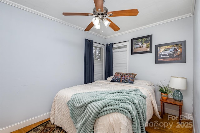 bedroom featuring ornamental molding, a ceiling fan, baseboards, and wood finished floors