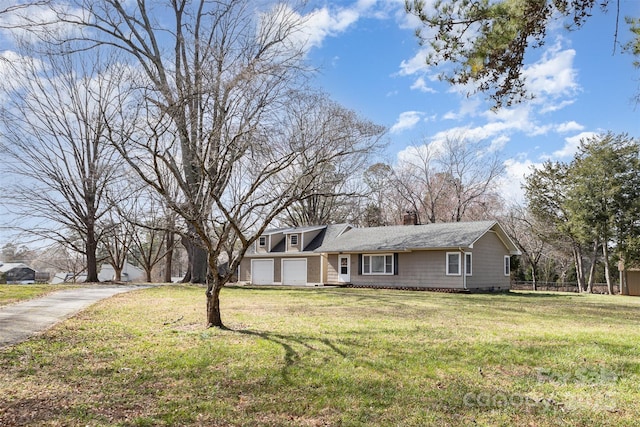 view of front of house featuring a front yard, driveway, a chimney, and fence