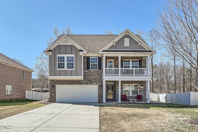 view of front of property featuring brick siding, concrete driveway, board and batten siding, a front yard, and fence