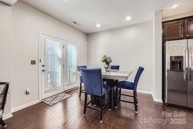 dining room with dark wood-style floors, visible vents, baseboards, and recessed lighting