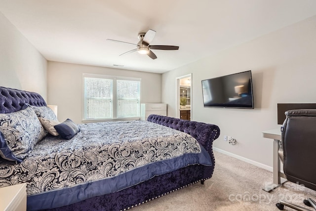 bedroom featuring visible vents, a ceiling fan, light carpet, ensuite bath, and baseboards