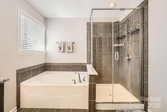 full bath with a stall shower, a garden tub, and vanity