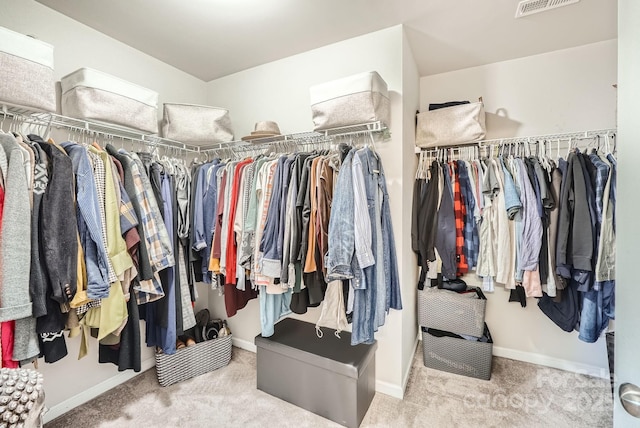 walk in closet featuring carpet flooring and visible vents