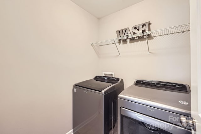 washroom featuring laundry area and separate washer and dryer