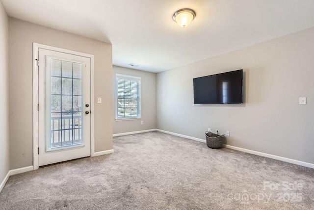 interior space featuring carpet flooring, visible vents, and baseboards