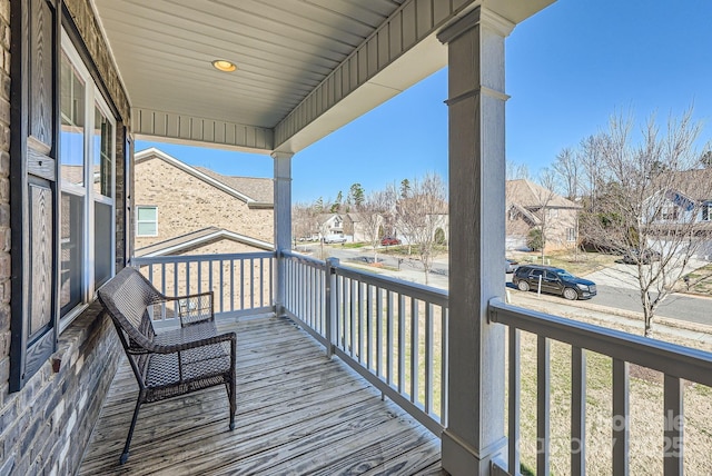 balcony featuring covered porch and a residential view