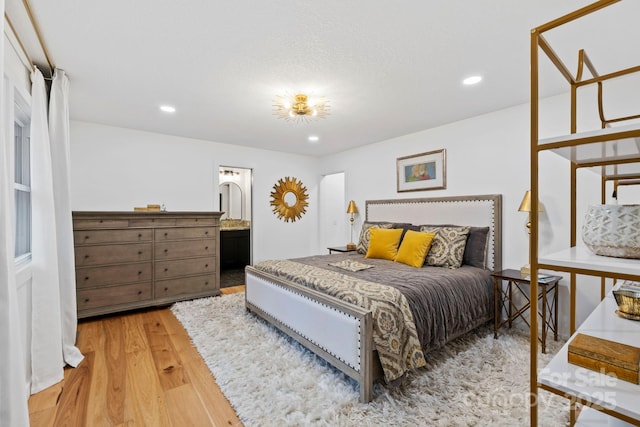 bedroom with wood finished floors and recessed lighting