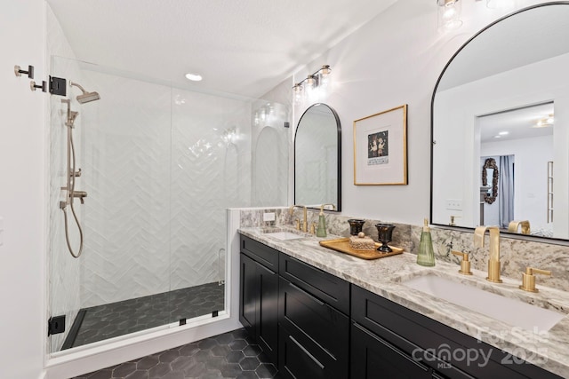 bathroom featuring double vanity, backsplash, a sink, and a shower stall