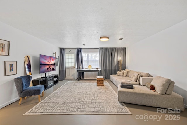 living area featuring visible vents and a textured ceiling