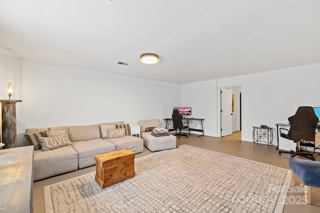 living room featuring concrete floors and visible vents