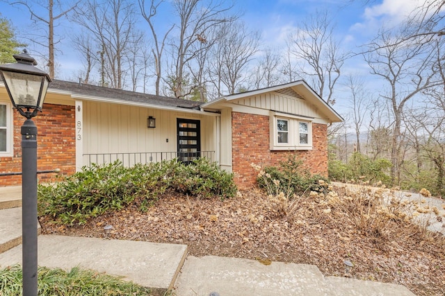 single story home featuring board and batten siding and brick siding