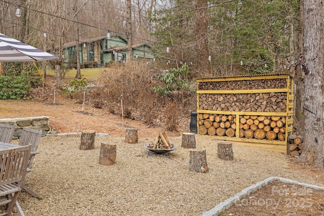 view of yard featuring an outdoor fire pit