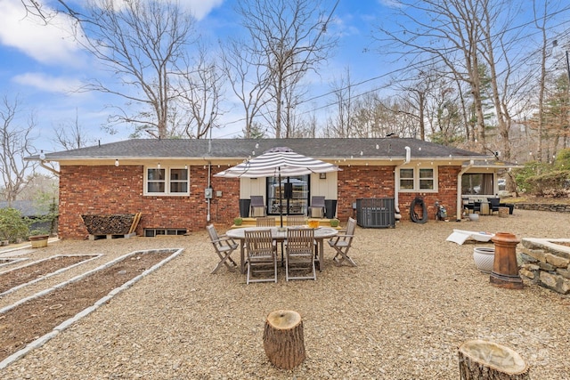 rear view of property with brick siding and cooling unit