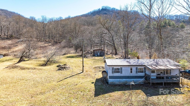 exterior space with a wooded view