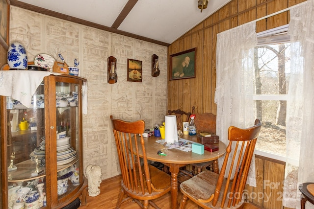 dining space with vaulted ceiling and wood finished floors