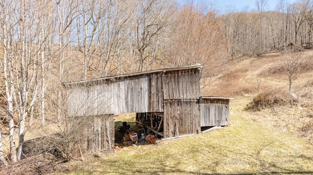 view of outbuilding featuring an outbuilding and a view of trees