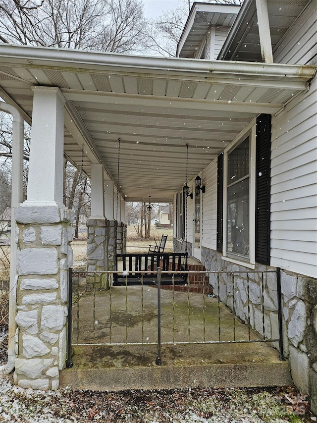 view of patio / terrace with covered porch and a carport