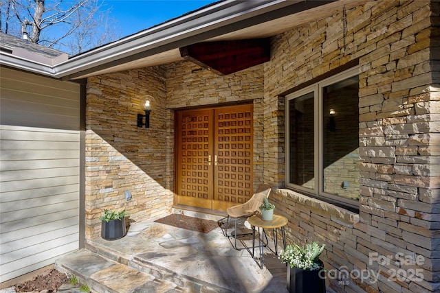 view of exterior entry featuring covered porch