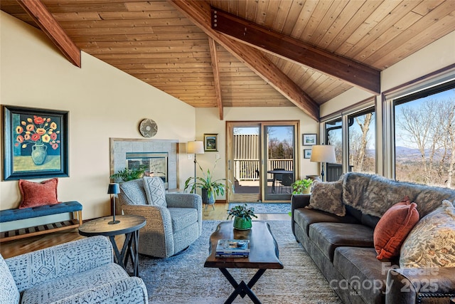 living room with beam ceiling, wood ceiling, and high vaulted ceiling