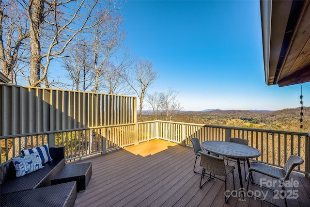 wooden terrace featuring outdoor dining space