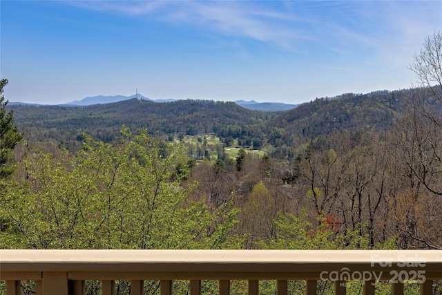 view of mountain feature with a view of trees