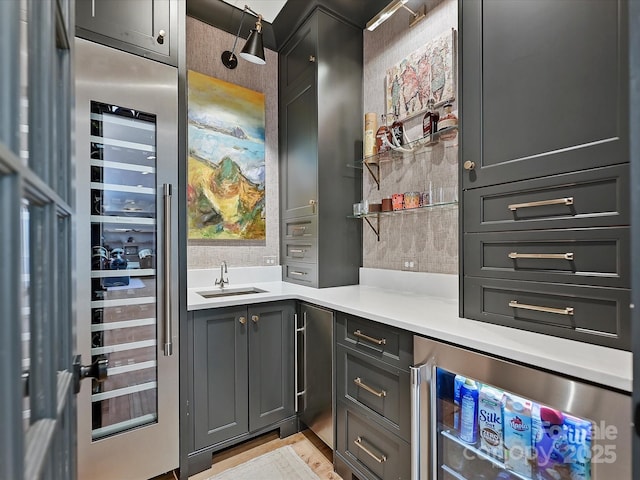 bar with beverage cooler and a sink