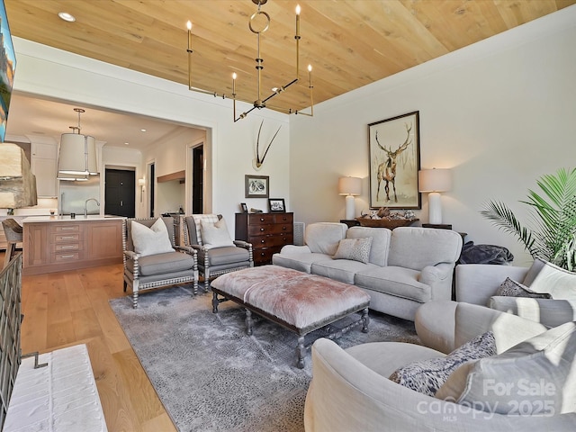 living area with light wood-style flooring, wood ceiling, and recessed lighting