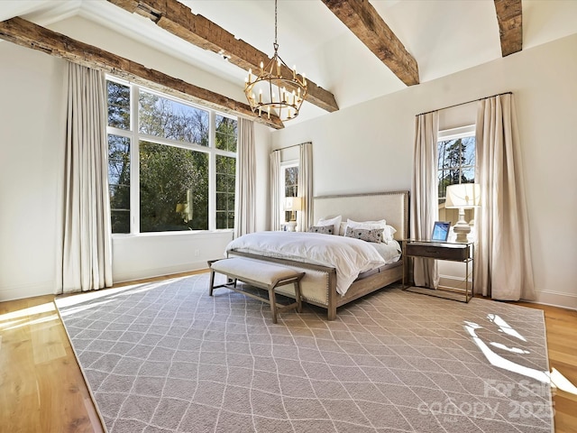 bedroom with baseboards, light wood-style flooring, a chandelier, and beamed ceiling