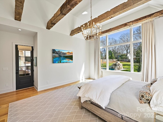 bedroom featuring an inviting chandelier, beamed ceiling, baseboards, and wood finished floors