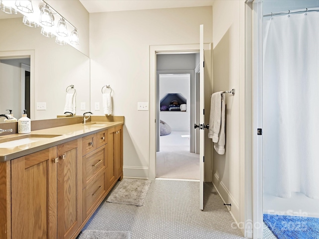 full bathroom featuring double vanity, a shower with shower curtain, a sink, and tile patterned flooring