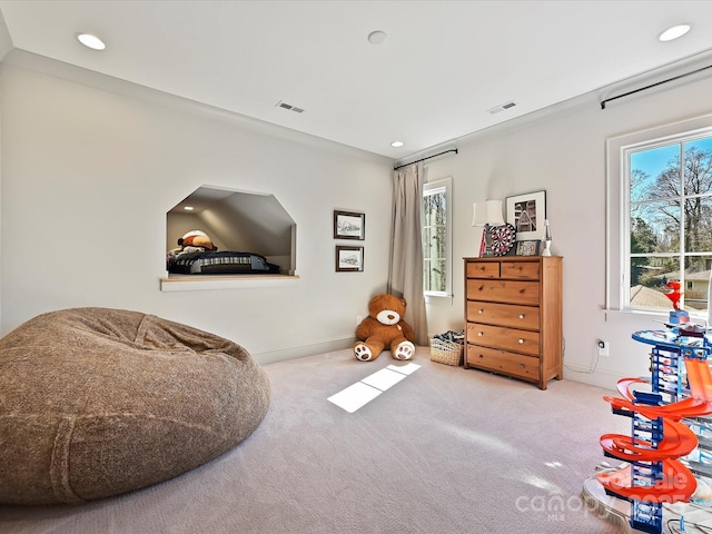 living area with recessed lighting, visible vents, and light colored carpet