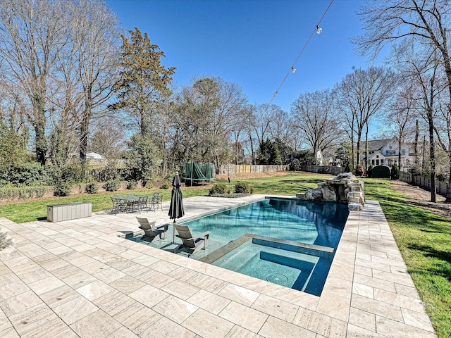 view of pool with a lawn, a fenced in pool, a patio, a fenced backyard, and an in ground hot tub