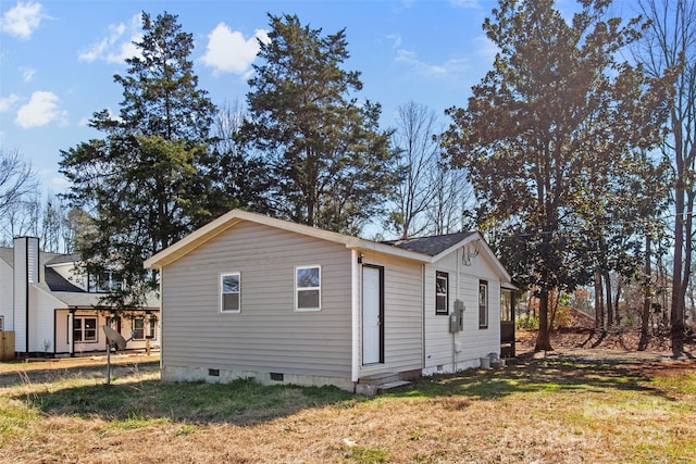 view of home's exterior featuring crawl space and a lawn