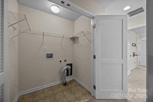 laundry area featuring hookup for a washing machine, hookup for an electric dryer, laundry area, visible vents, and baseboards