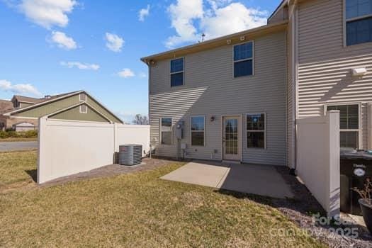 back of house featuring central AC, a yard, fence, and a patio